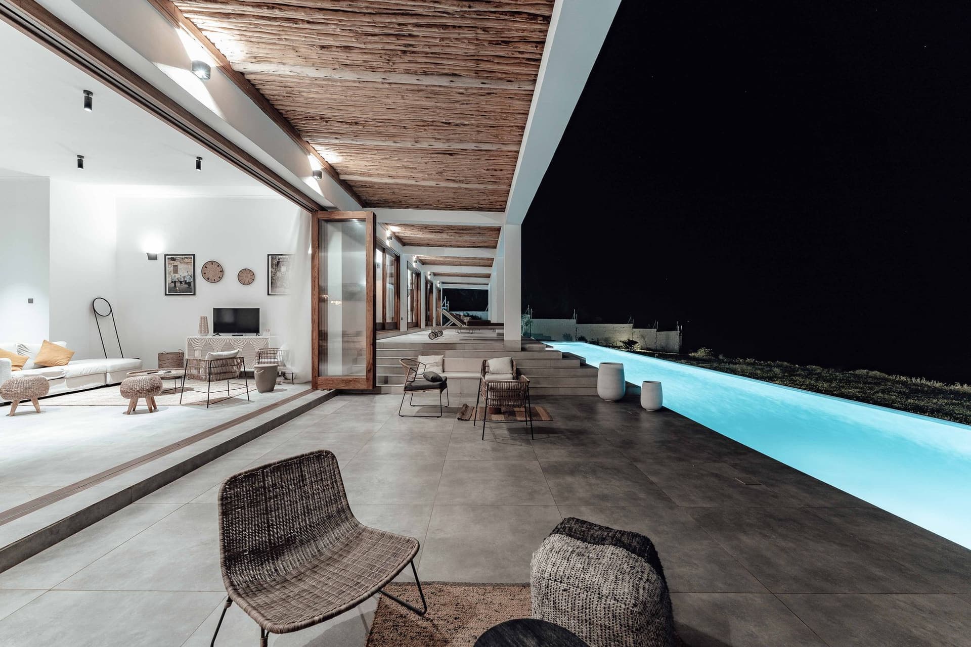 A villa and pool lit at night