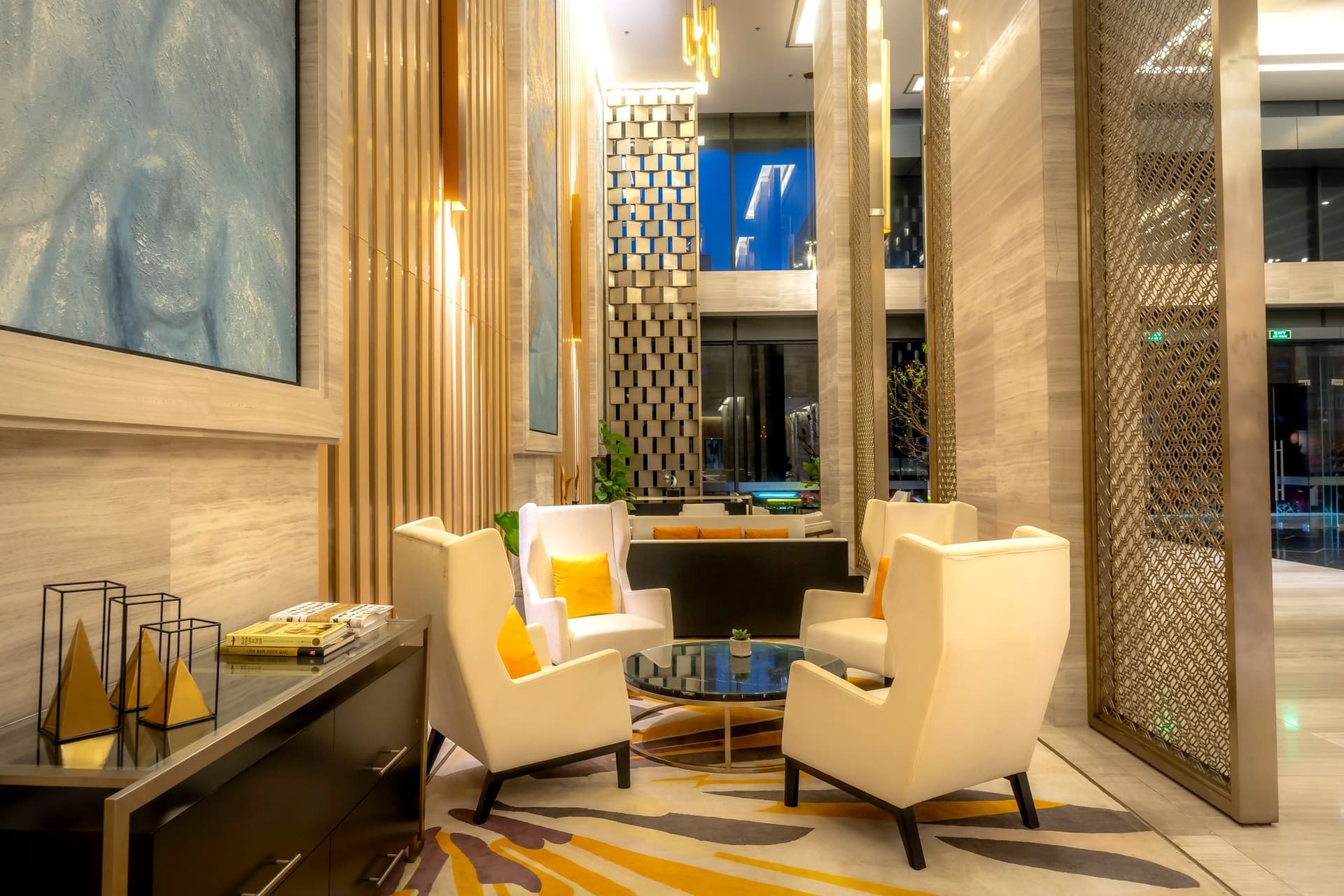 A warmly lit lobby with lounge seating